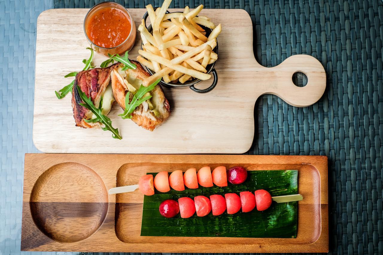 Fusion Suites Phuket Patong Bagian luar foto A wooden cutting board with a handle