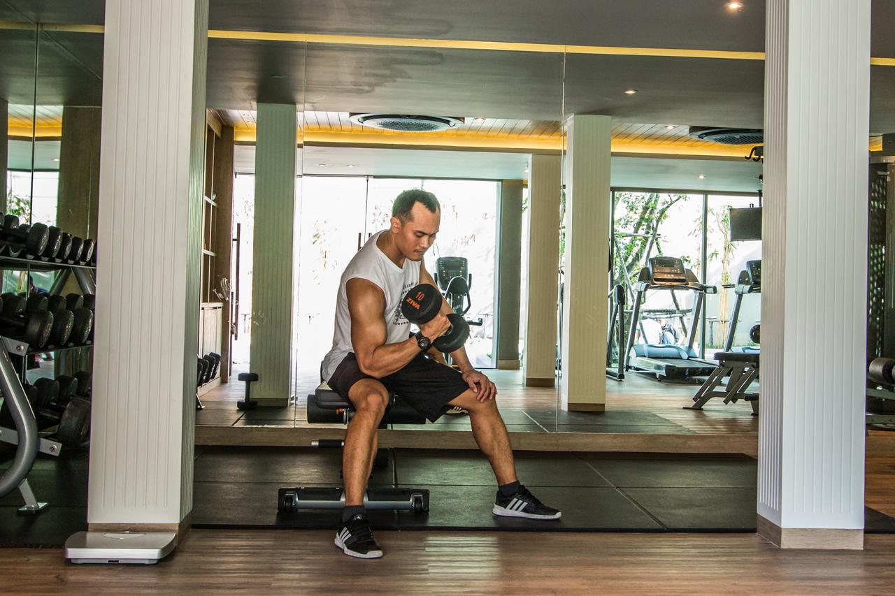 Fusion Suites Phuket Patong Bagian luar foto A man lifting weights